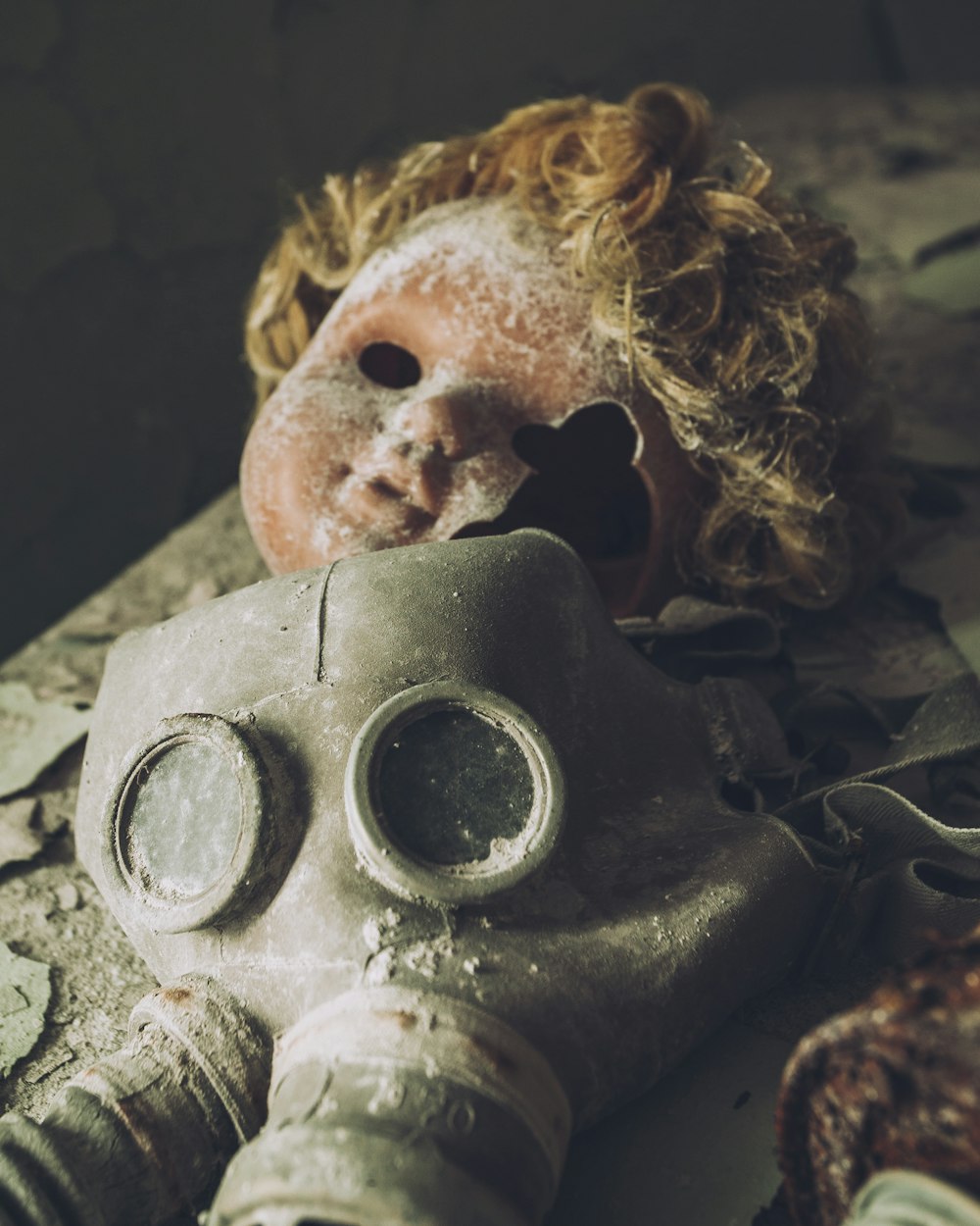 a dirty doll with a gas mask on