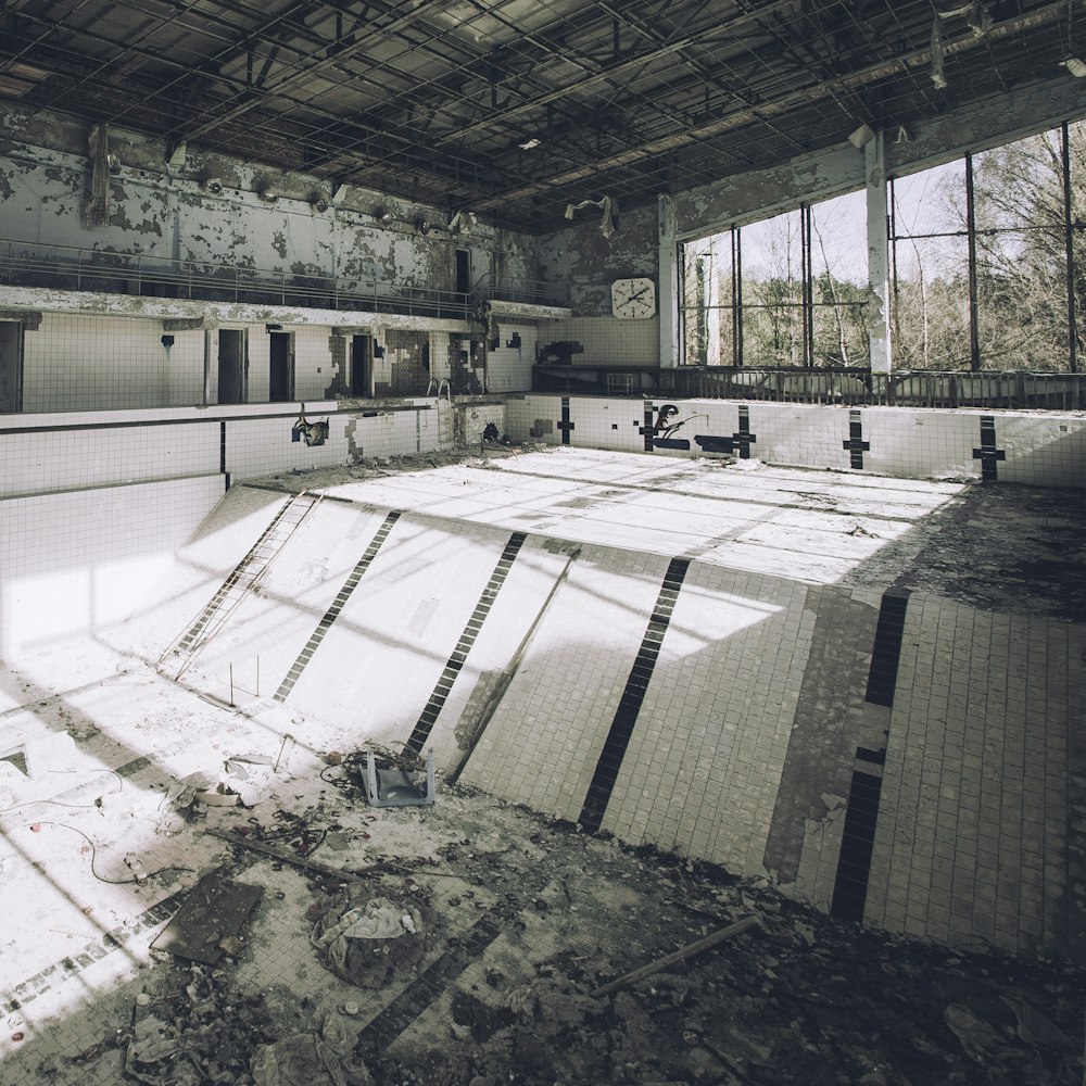 an empty swimming pool in an abandoned building