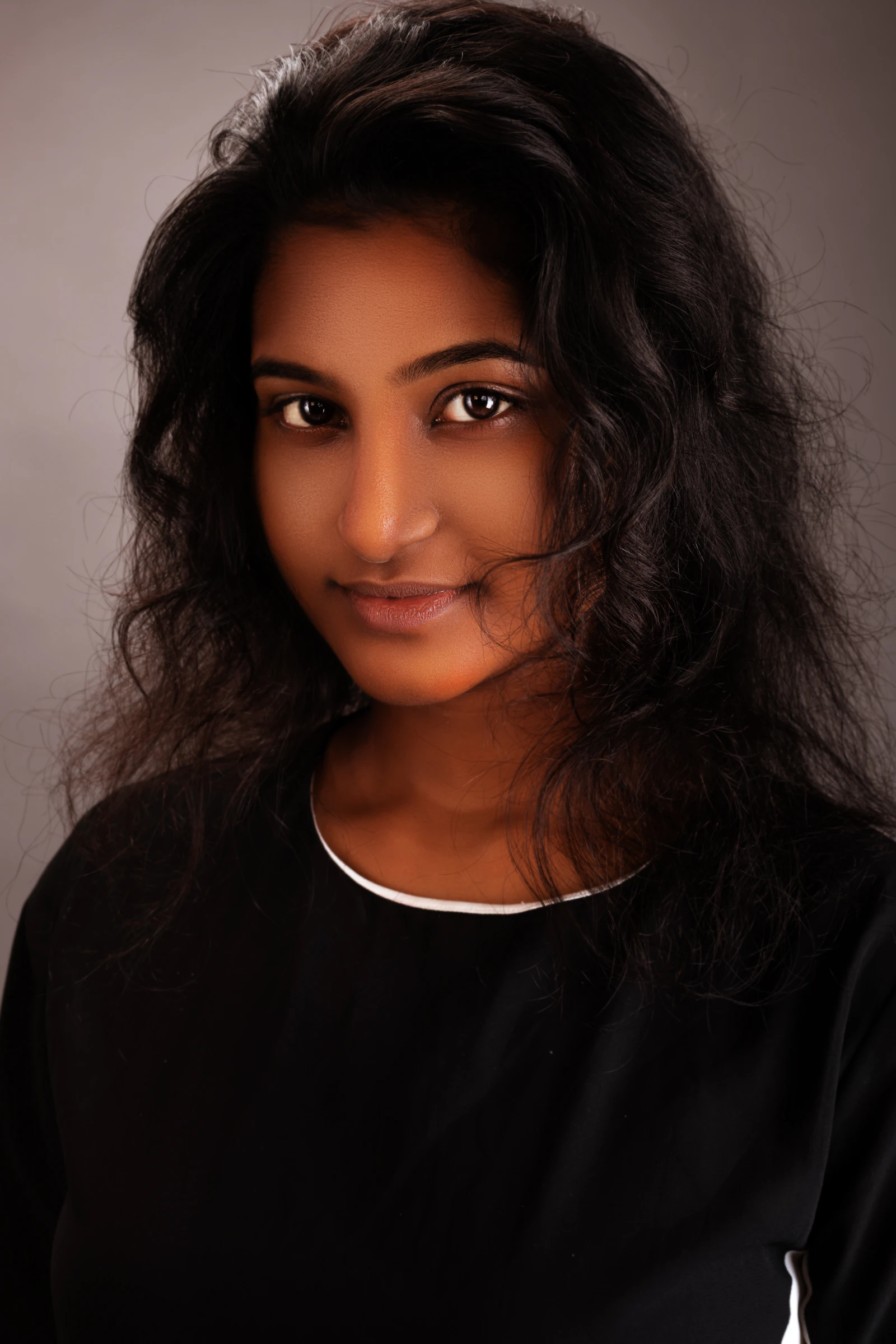 Portrait of a mentor with long hair in a black shirt