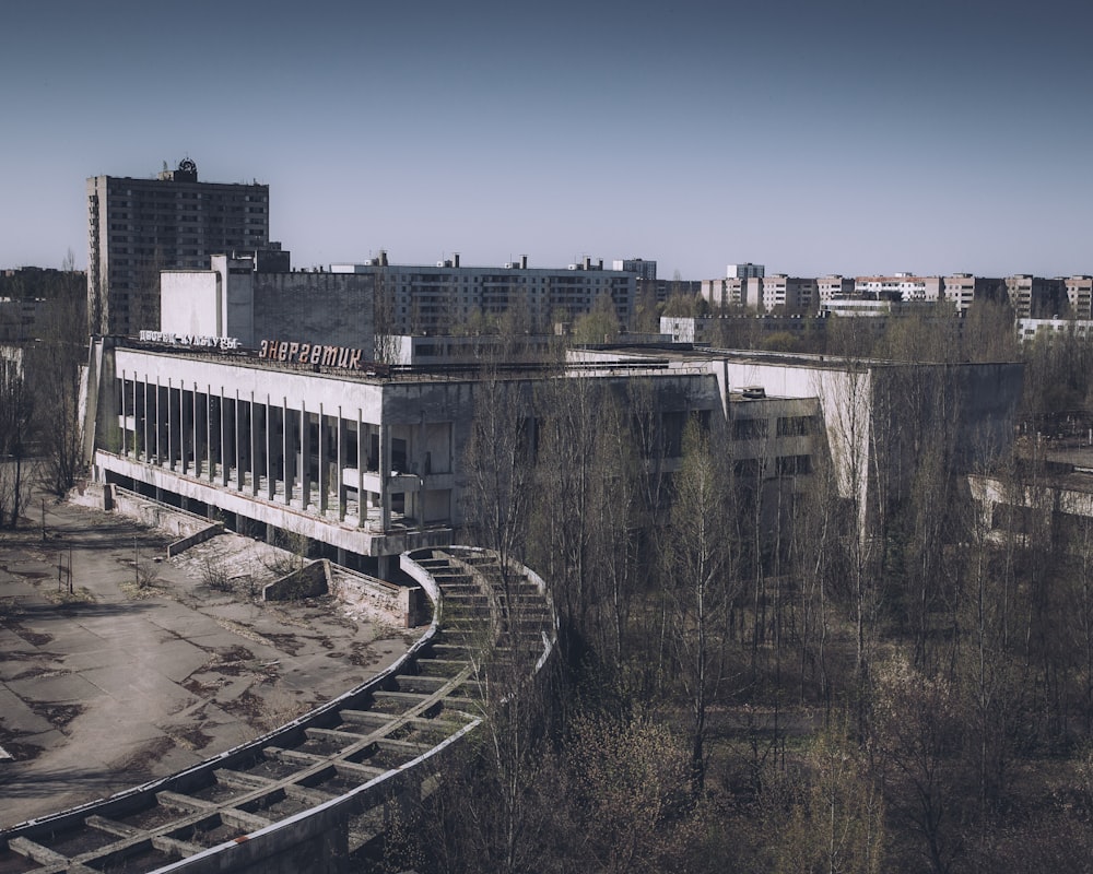 a train track running through a city with tall buildings in the background