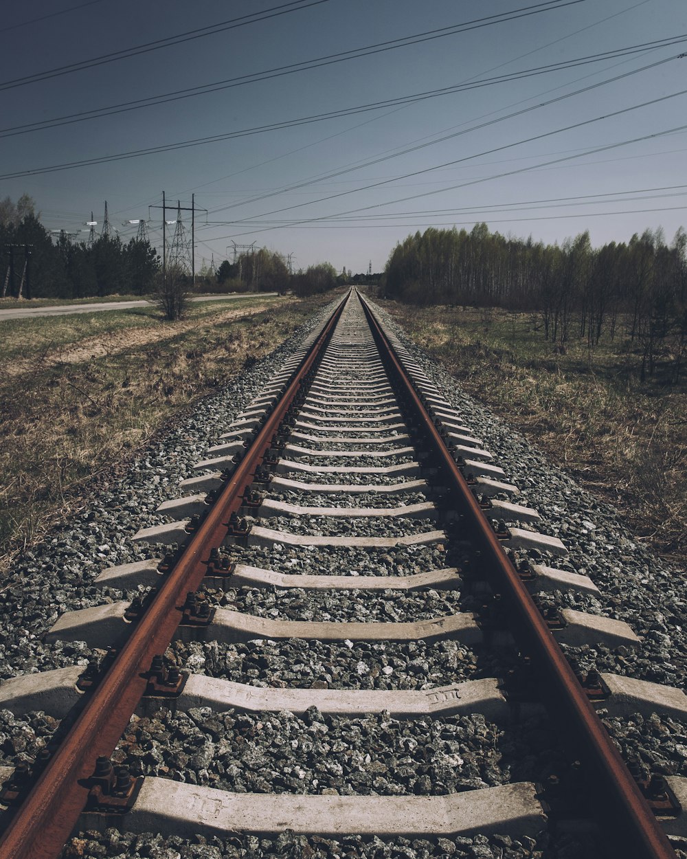 a train track with a sky in the background