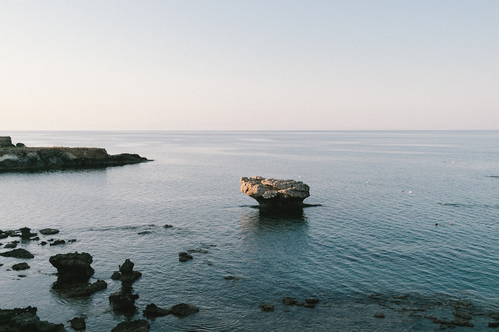 a rock outcropping in the middle of a body of water