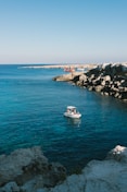 a small boat floating on top of a body of water