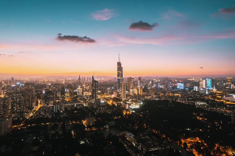 a view of a city at night from the top of a hill