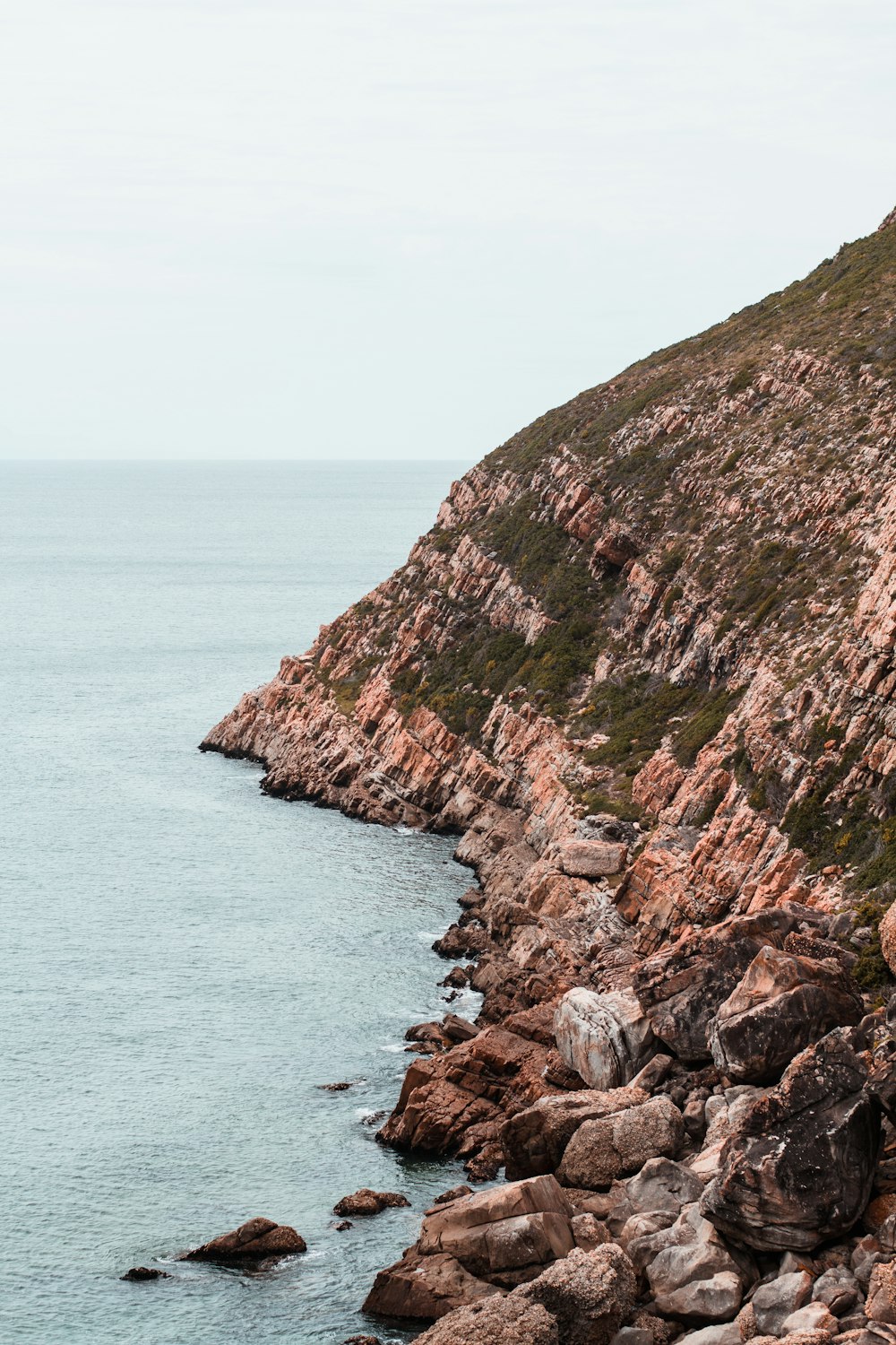 a rocky shore line with a body of water