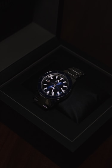 a watch sitting in a black box on a table