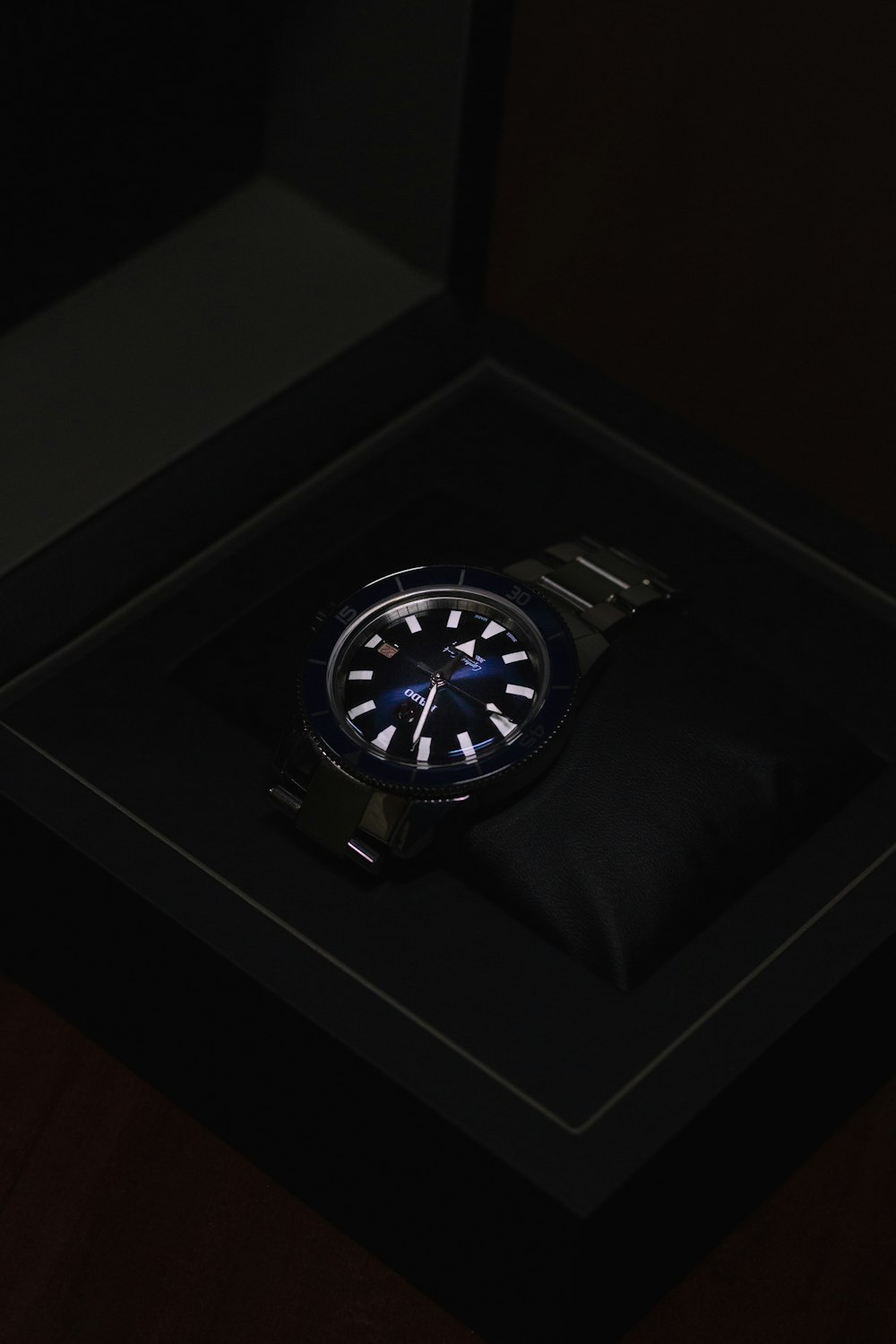 a watch sitting in a black box on a table