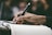 Close-up of hands holding a notebook and pen during a training session.