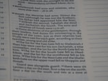 A close-up of a page from a book with text in two columns. The text describes various duties and divisions related to gatekeepers and lots cast for different gates. The layout includes numbered verses and sections, typical of a religious or historical text.