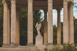 a statue of an angel on a pedestal surrounded by pillars