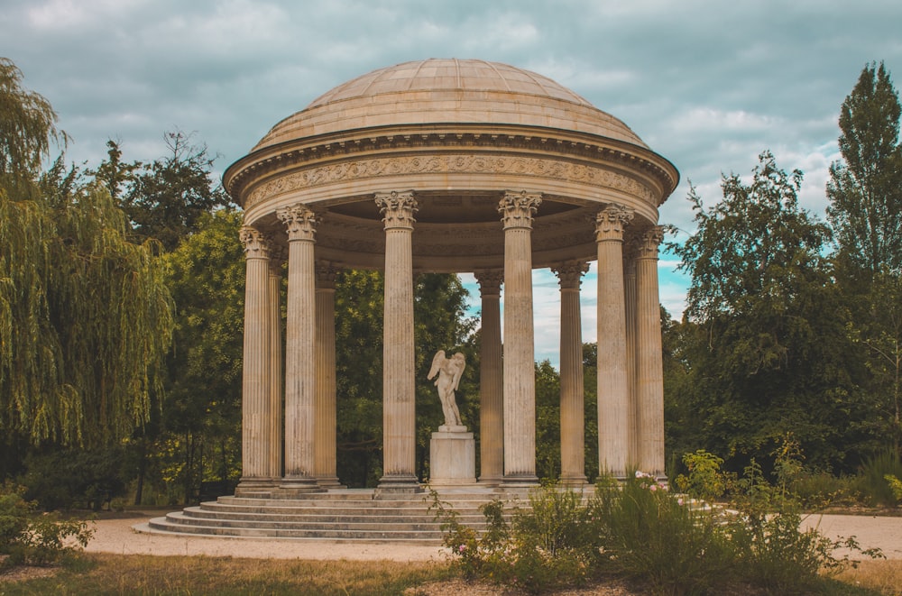 a gazebo with a statue in the middle of it