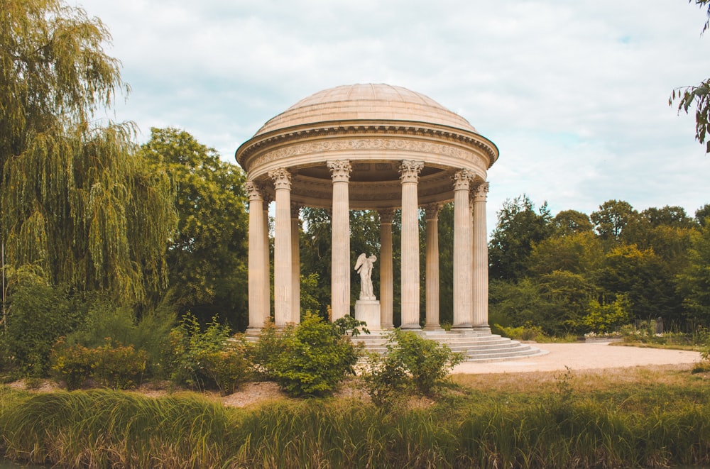 a gazebo with a statue in the middle of it