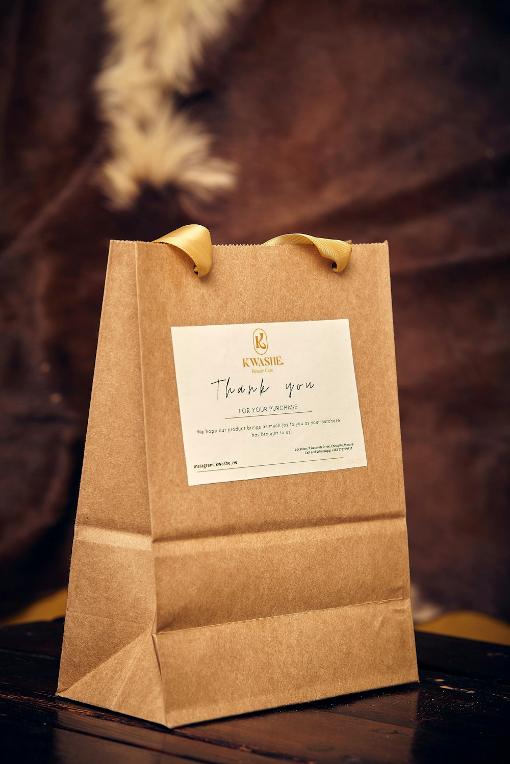 a brown paper bag sitting on top of a wooden table