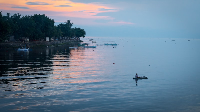 Kayaker on calm coastal water