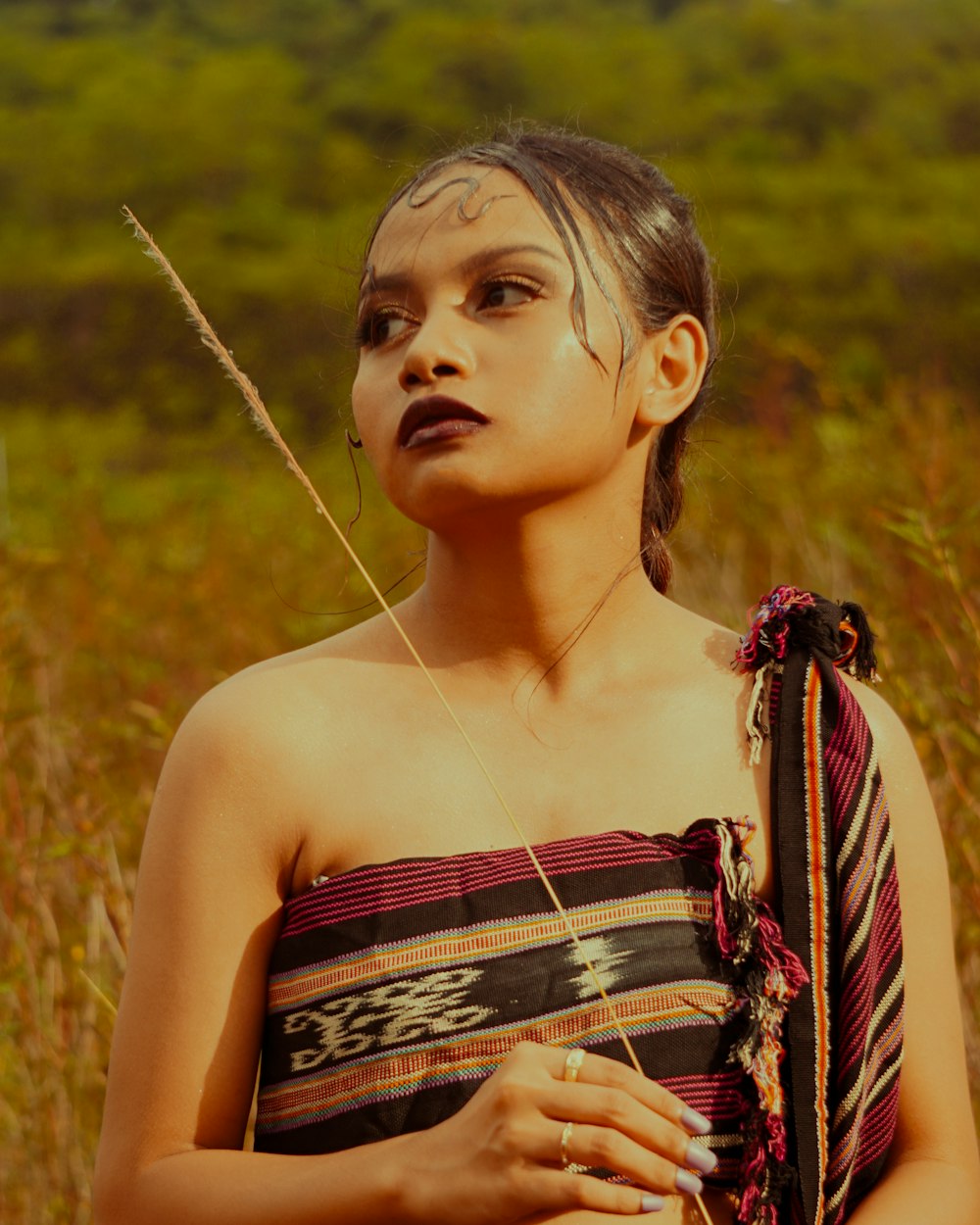 a woman in a dress standing in a field