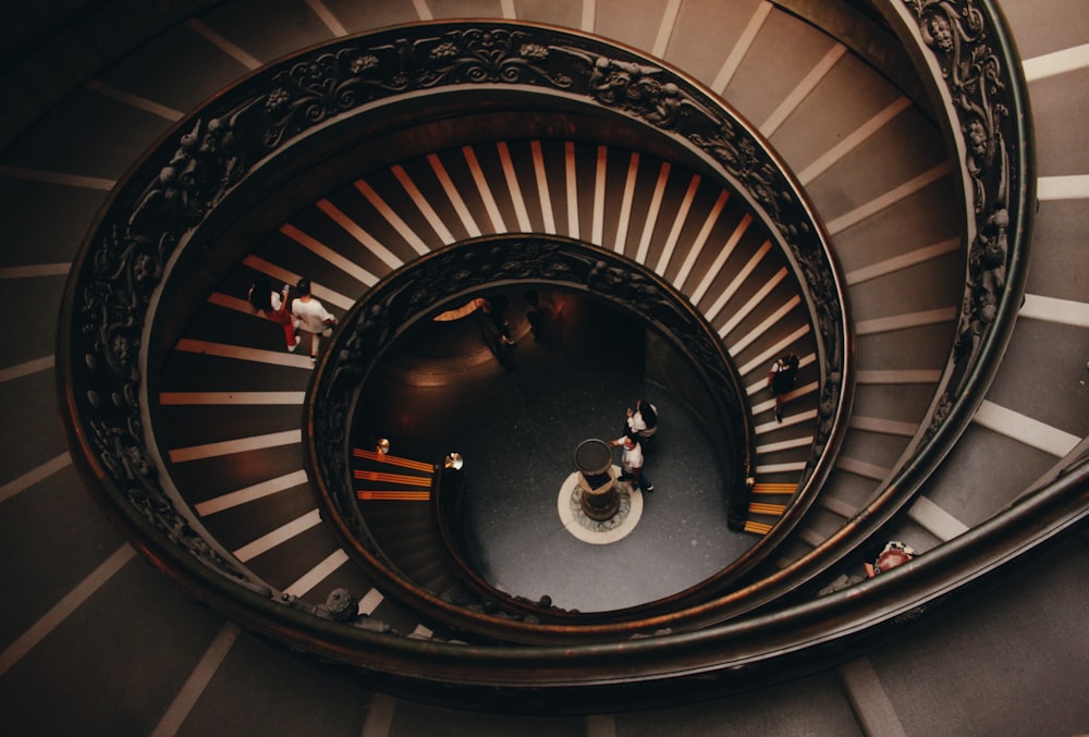 a spiral staircase with people walking down it