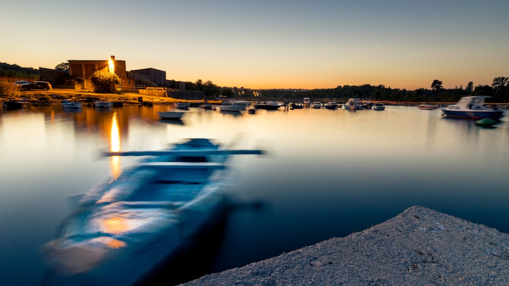 a row of boats floating on top of a lake