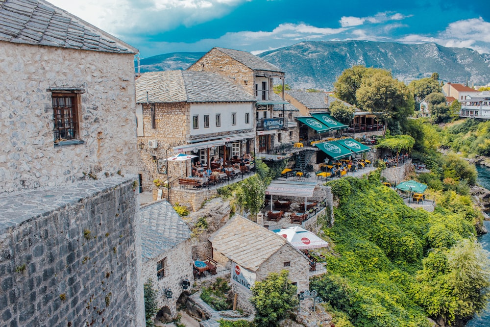 a river running through a small town surrounded by mountains