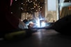 a person using a welding machine on a table