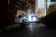 a person using a welding machine on a table