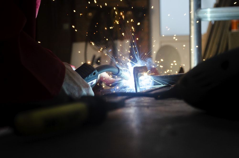 a person using a welding machine on a table