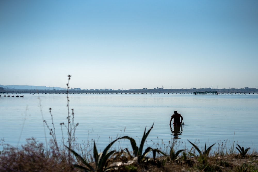 a person wading in a body of water