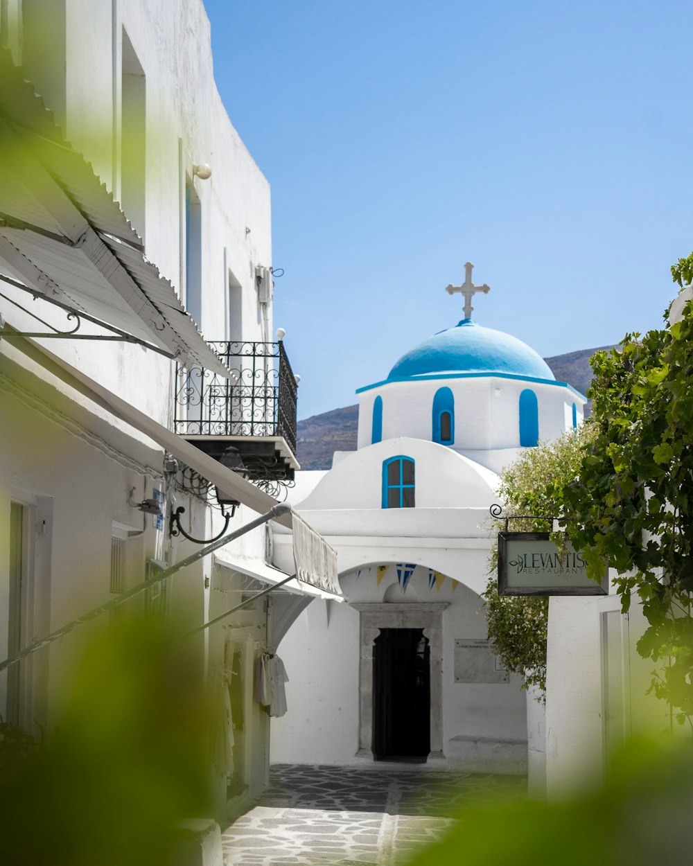 a blue and white building with a cross on top