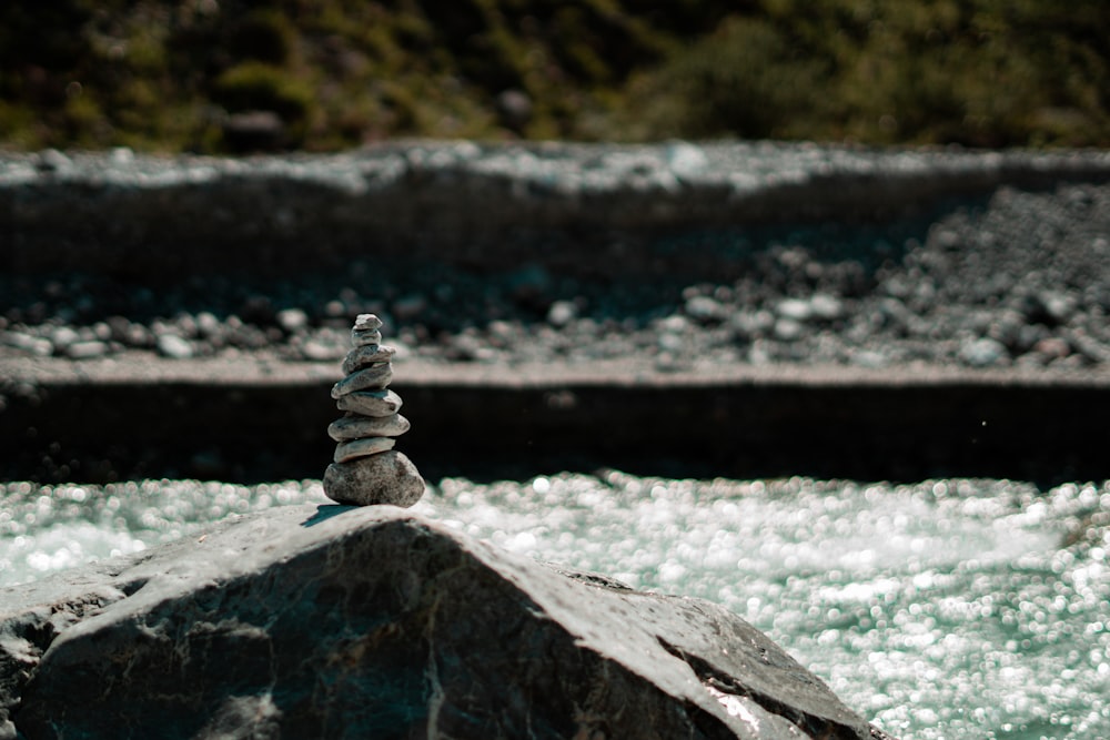 a pile of rocks sitting on top of a river