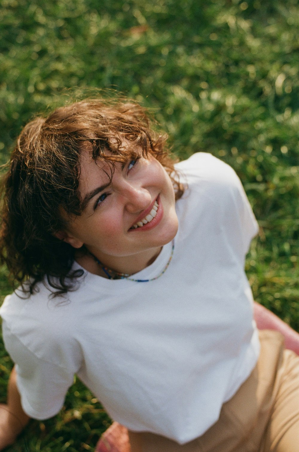 a woman laying on the ground with a frisbee in her hand