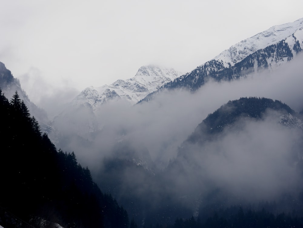 a view of a mountain range covered in clouds