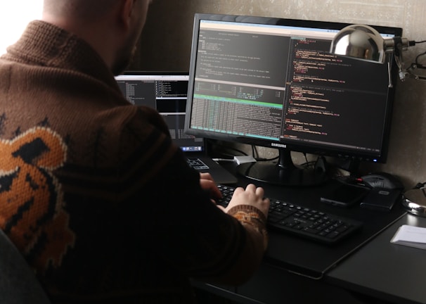 a man sitting in front of a computer on a desk