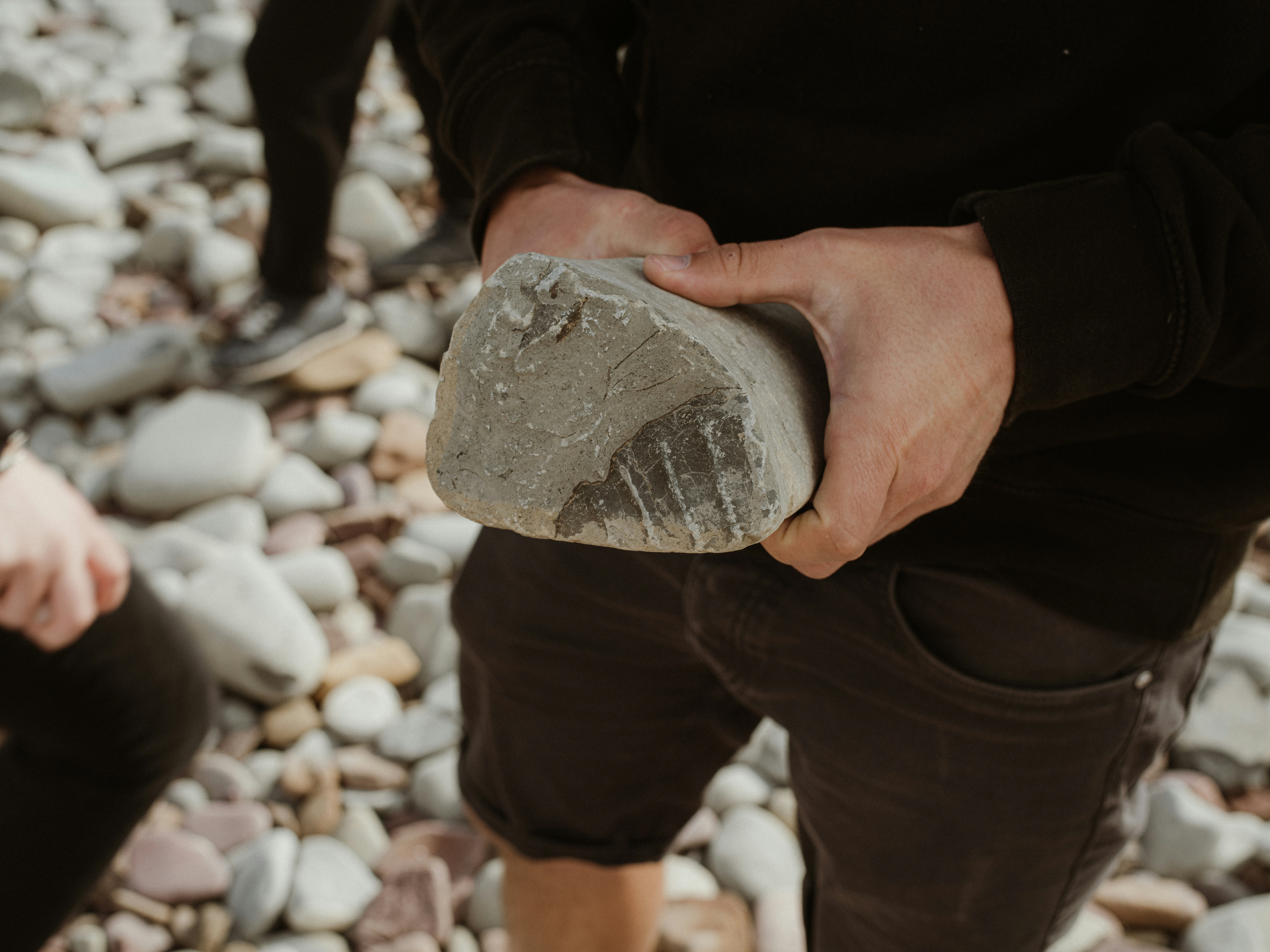 a man holding a rock in his hands