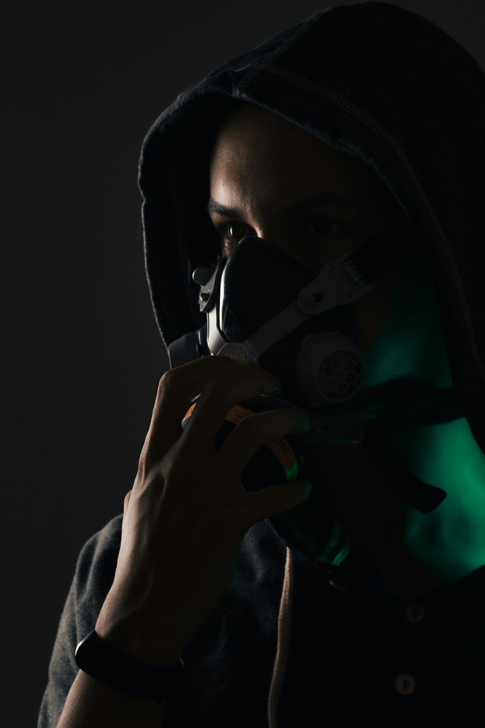 a man in a hoodie holding a pair of scissors