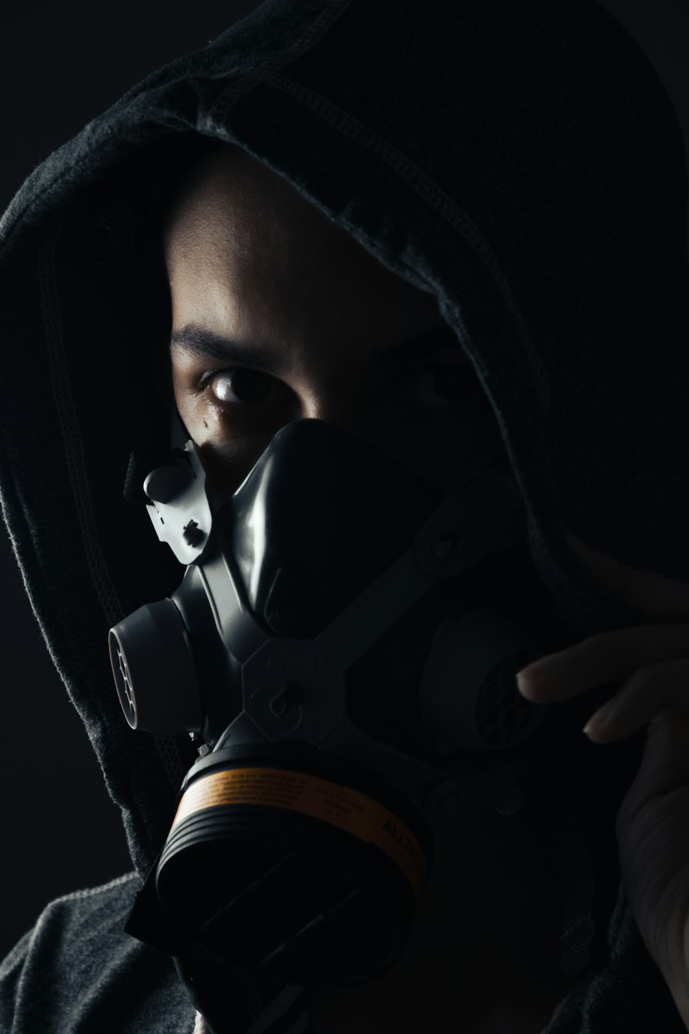 a man wearing a gas mask in the dark