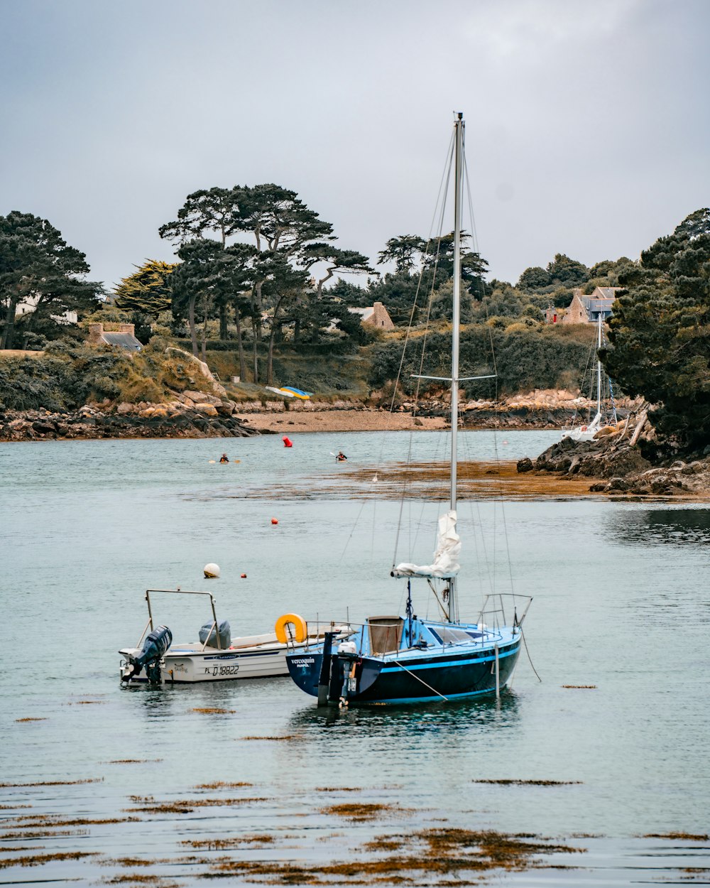 a couple of boats floating on top of a body of water