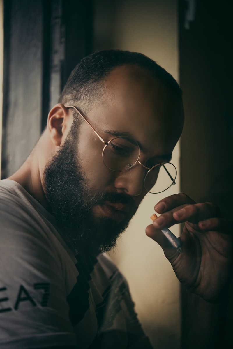 남성이 목 부위에 향수를 뿌리는 모습