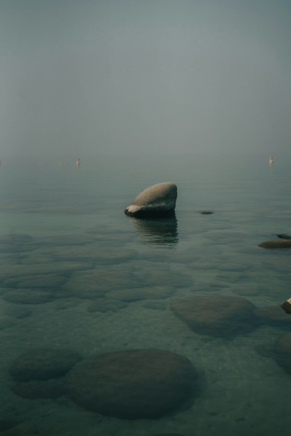 a rock in the middle of a body of water