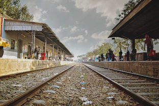 a train station with people waiting for the train