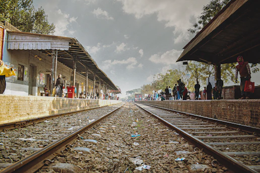 a train station with people waiting for the train