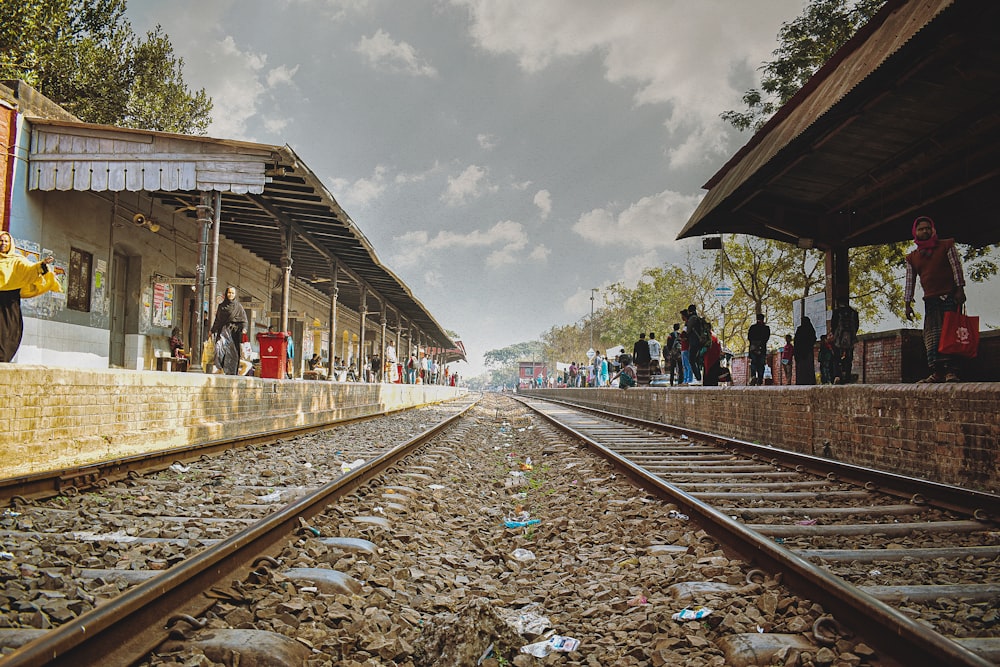 a train station with people waiting for the train