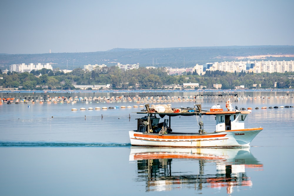 a small boat floating on top of a large body of water