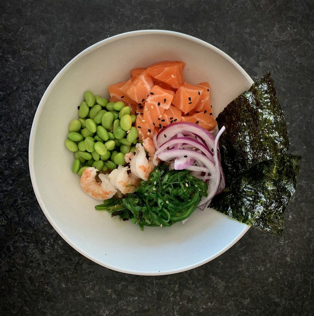 a white bowl filled with different types of food