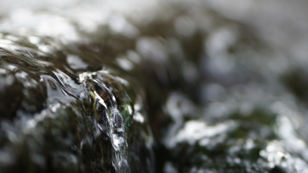 a close up view of water flowing over rocks