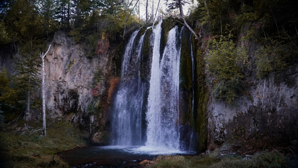 a large waterfall with water cascading down it's sides