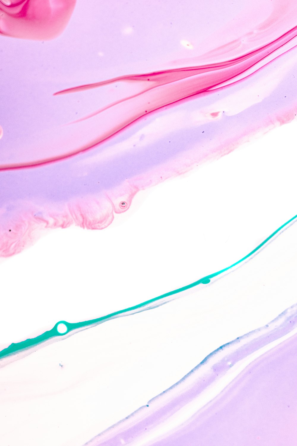 a close up of a pink and purple liquid