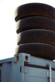 Various containers of liquid tire ballast products lined up on a workbench.