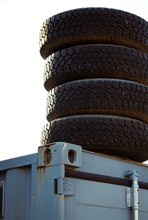 Close-up of rugged forklift tyres stacked and ready for shipment.