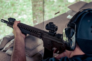 a man is aiming a rifle at a target