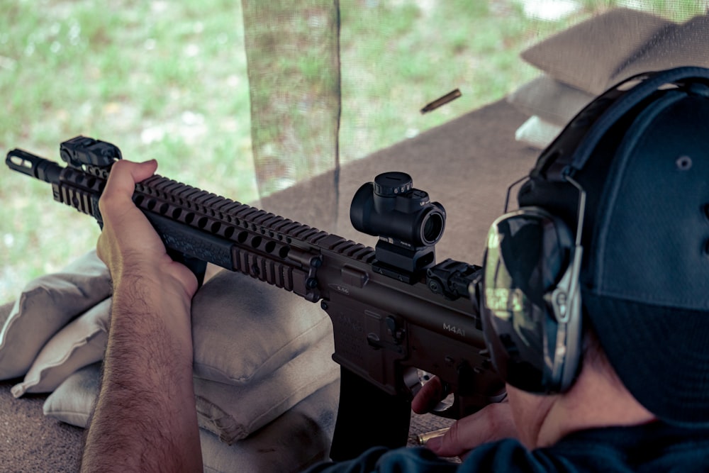 a man is aiming a rifle at a target