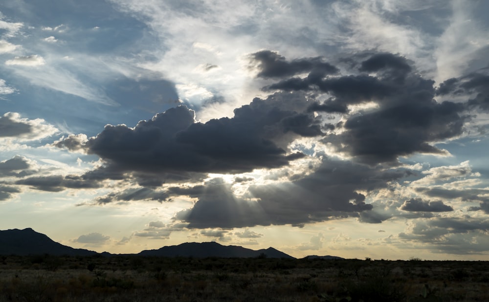 the sun is shining through the clouds in the sky